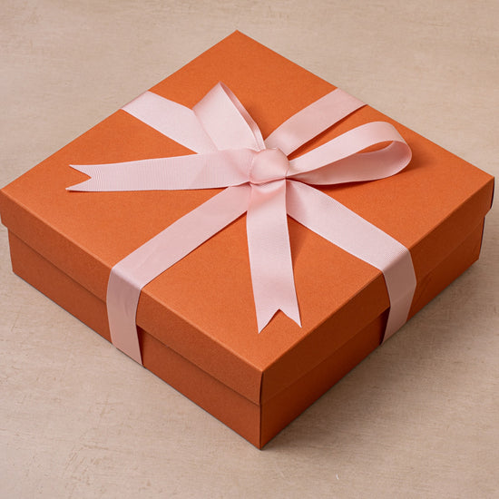 Orange and pink gift box with ribbon