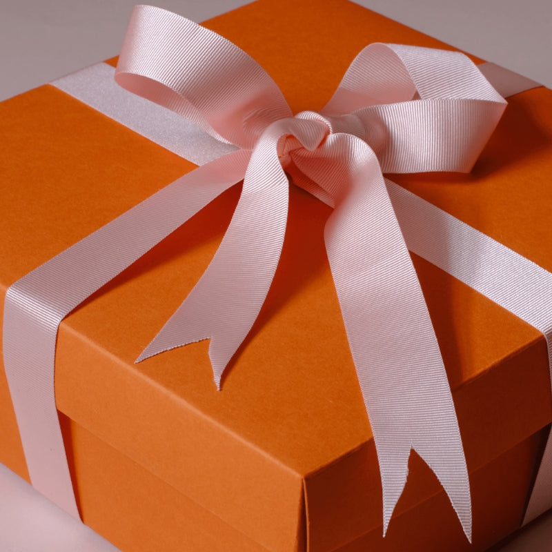 orange gift box with pink ribbon