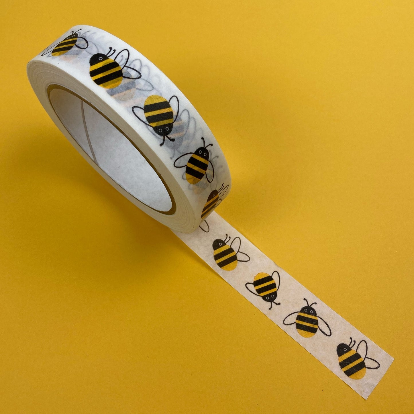 Decorative tape with bee pattern on a yellow background