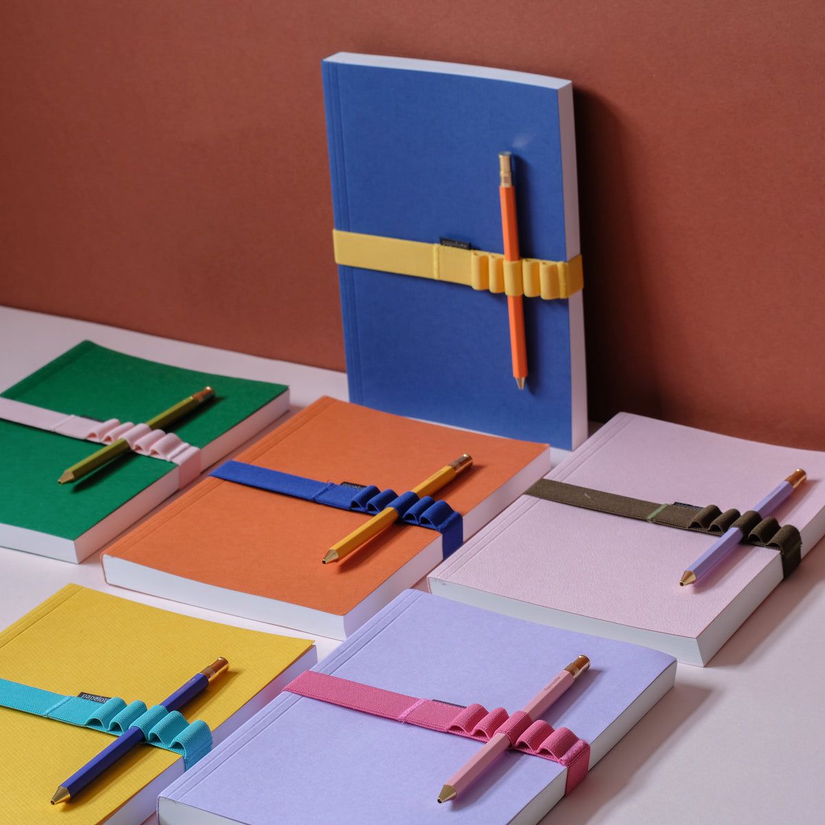 Different Coloured Notebooks in Pastel and Bright Colours with Matching Pens and Notebook Bands