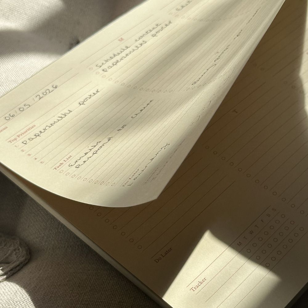 Open notebook with handwritten notes on a textured surface