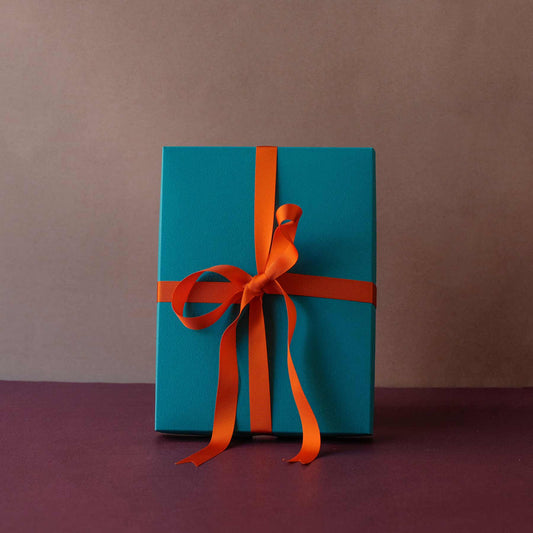 Teal gift box with ribbon