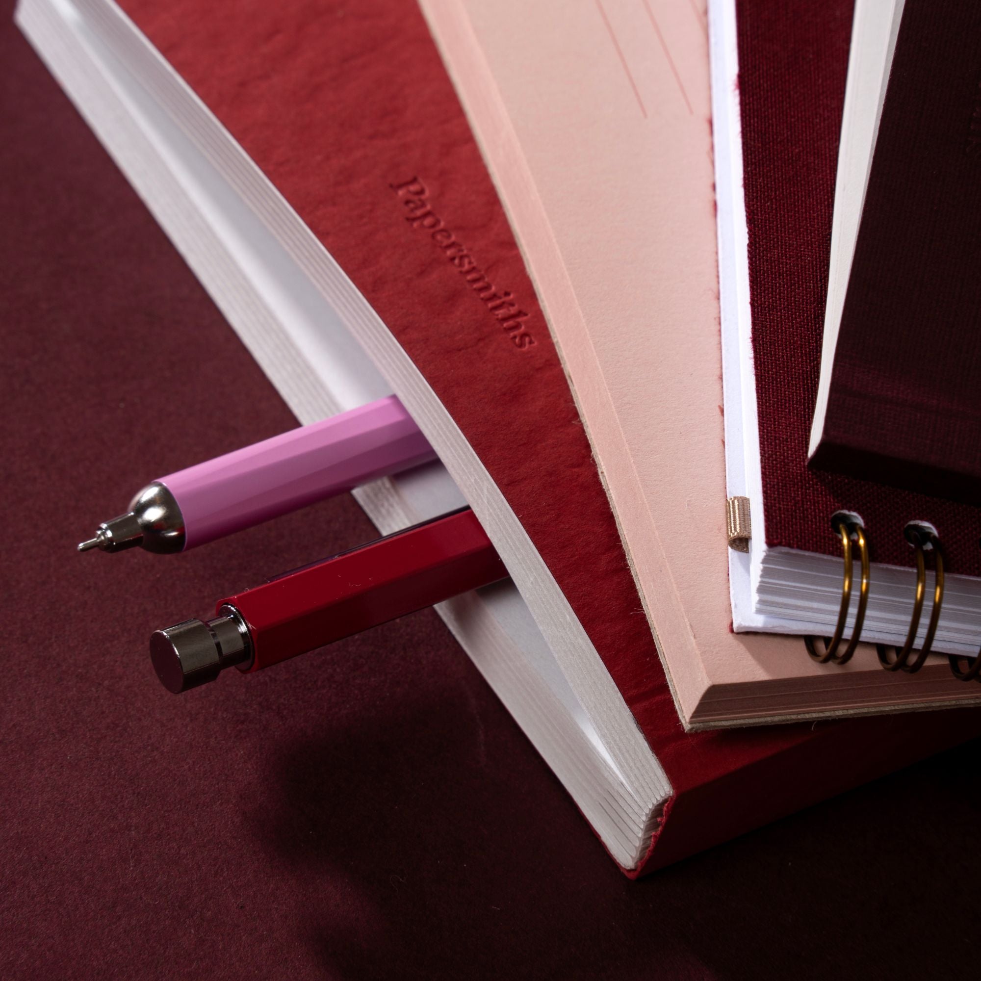 book stack with pens sticking out