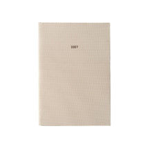 A vertical 2027 fabric-covered planner or agenda with a textured beige linen cover and the year '2027' printed in small black text near the top center, shown on a plain white background.