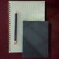 Two 2026 wiro green notebooks and a pen on a dark red background papersmiths