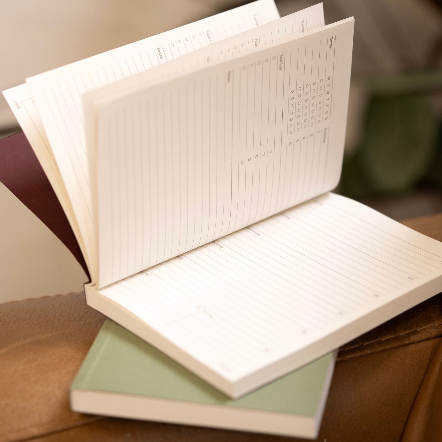 Open notebook 2026 diary pocket sized with lined pages on a wooden surface