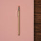 Beige pocket pencil on pink notebook