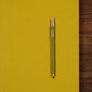 Green pencil on a yellow background