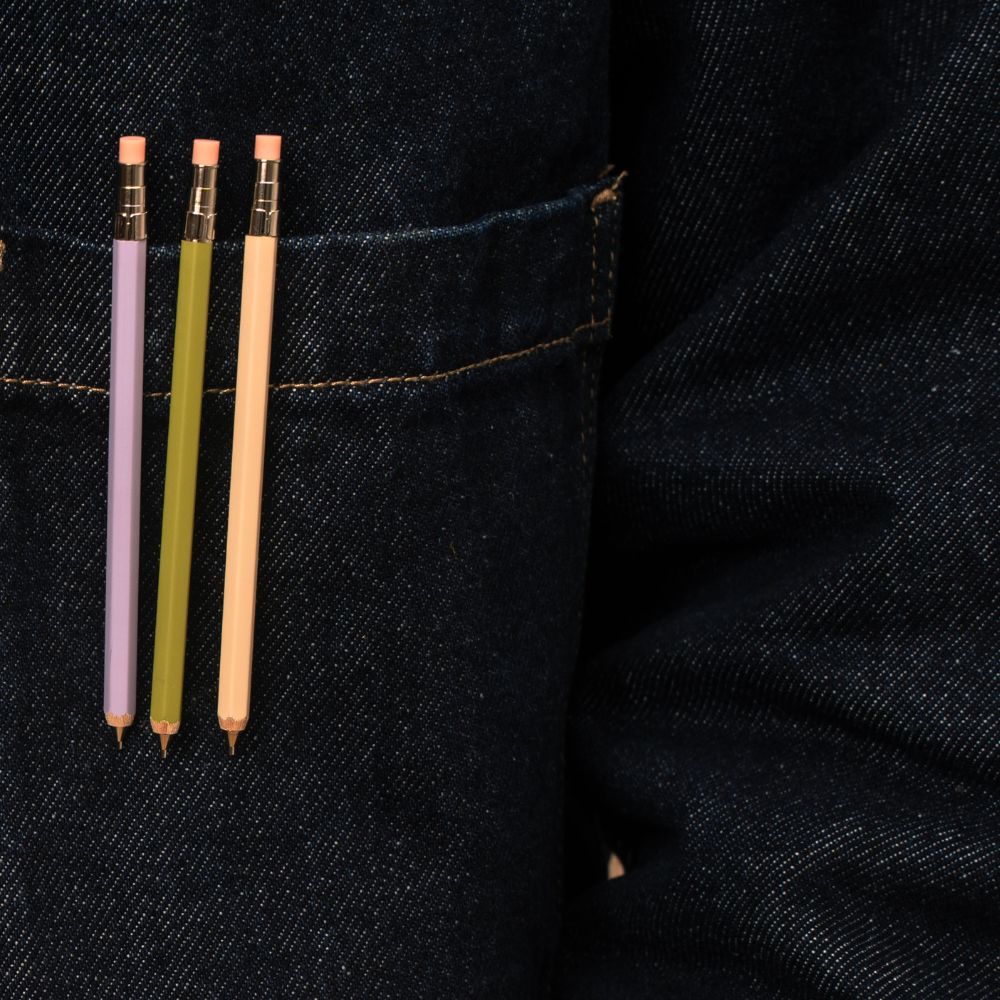 3 pocket-sized pencils clipped to a denim pocket