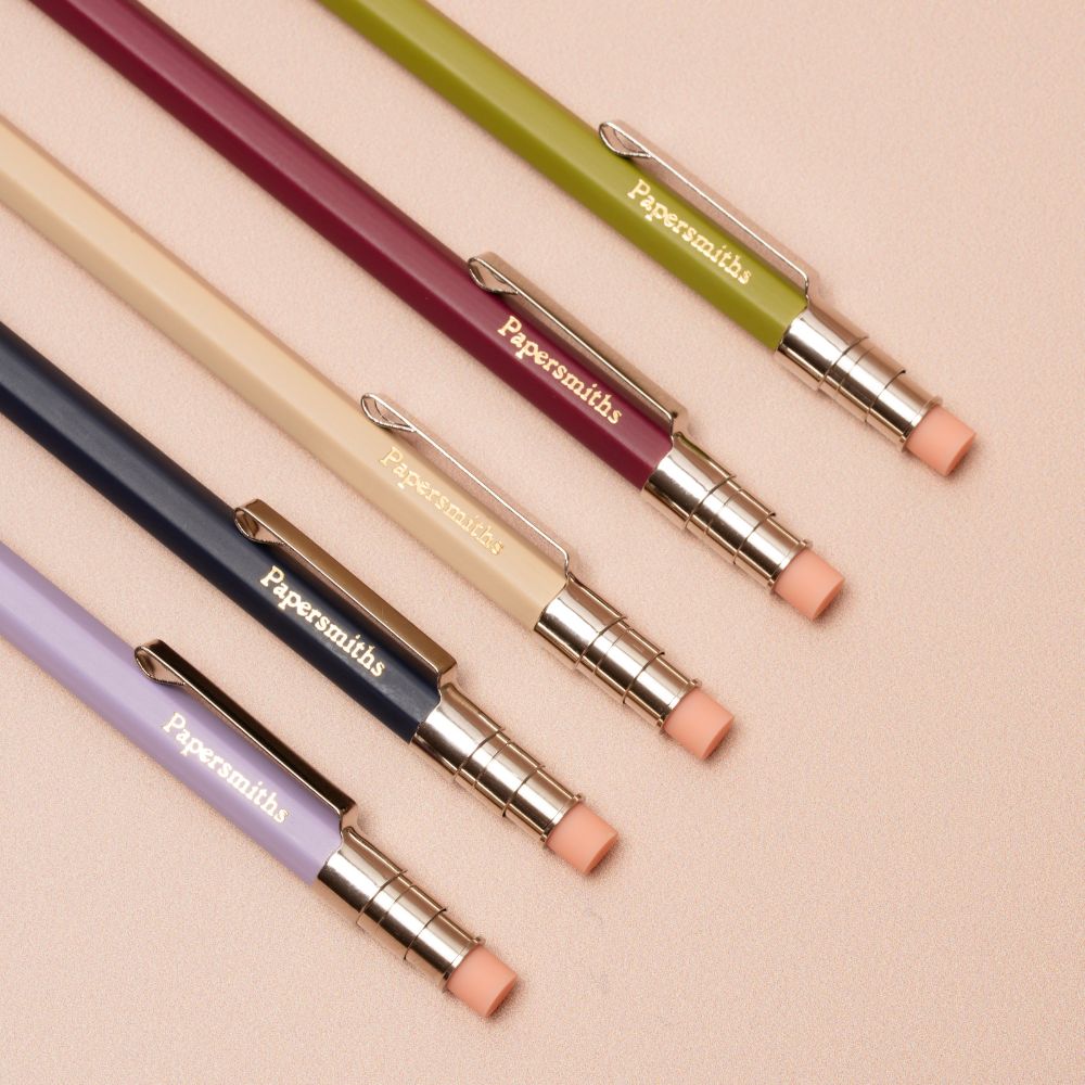 Set of colorful pocket pencils with 'Papersmiths' branding on a beige background