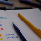 blue and yellow sign pens