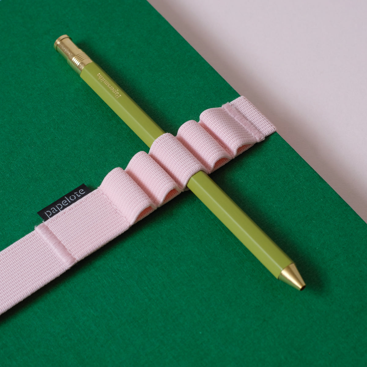 green notebook with green pen