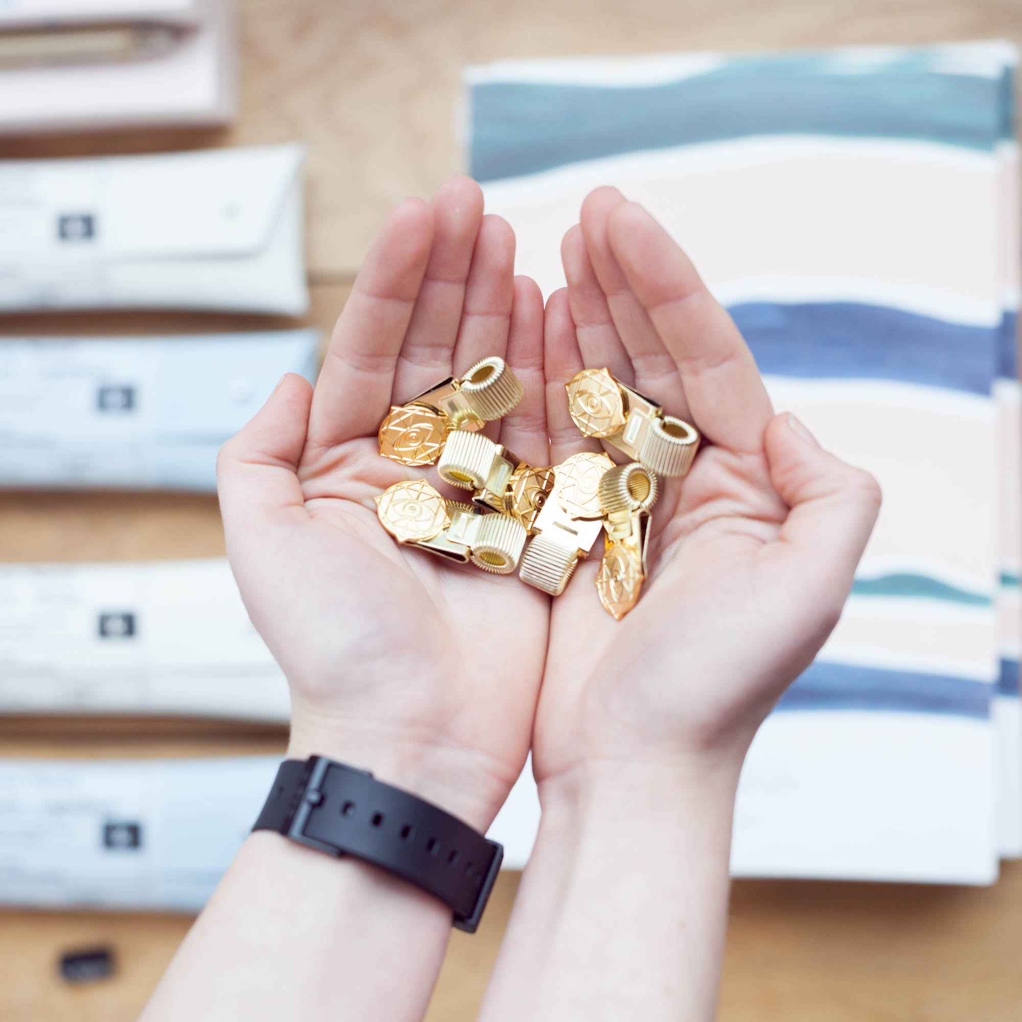Gold Rama Eye Clips in hands
