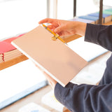 Gold Pen Clip attached to Notebook