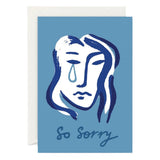 A greeting card with a blue background featuring an illustration of a face with a tear and the text 'So Sorry' printed below it.